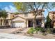 Charming two-story home with a well-kept lawn, a two car garage, and decorative desert landscaping at 1163 Highbury Grove St, Henderson, NV 89002