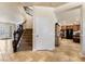 Inviting hallway with travertine floors leading to the staircase and kitchen area at 1163 Highbury Grove St, Henderson, NV 89002