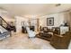 Inviting living room with elegant furniture, travertine floors, and a view into the dining area at 1163 Highbury Grove St, Henderson, NV 89002