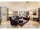 Warm and inviting living room featuring leather furniture, tile flooring, and natural light at 1163 Highbury Grove St, Henderson, NV 89002