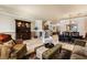 Open-concept living area with travertine floors, view of formal dining, and traditional furnishings at 1163 Highbury Grove St, Henderson, NV 89002