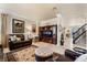 Comfortable living room with dark brown leather furniture, a patterned rug, and a built-in entertainment center at 1163 Highbury Grove St, Henderson, NV 89002