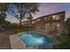 Backyard view showcasing a pristine pool, lush landscaping, and a spacious patio for outdoor entertaining at 1163 Highbury Grove St, Henderson, NV 89002