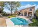 Inviting backyard pool with patio, lush landscaping, and outdoor seating area at 1163 Highbury Grove St, Henderson, NV 89002