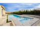 Backyard pool and spa with lush landscaping and a relaxing patio area with lounge chairs under a blue sky at 11895 Skyline Arch Ct, Las Vegas, NV 89138