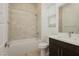 Clean bathroom featuring a shower-over-tub combo, sleek vanity, and modern fixtures at 11895 Skyline Arch Ct, Las Vegas, NV 89138