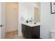 Modern bathroom with a double vanity, white countertops, and a large mirror at 11895 Skyline Arch Ct, Las Vegas, NV 89138