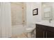 Bathroom with a shower-tub combo, neutral tile, and modern vanity with sink at 11895 Skyline Arch Ct, Las Vegas, NV 89138