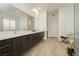 This bathroom features a double vanity, a large mirror, and a walk-in shower at 11895 Skyline Arch Ct, Las Vegas, NV 89138