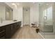 The bright bathroom features dual sinks with a large vanity, a shower with a glass door, and modern fixtures at 11895 Skyline Arch Ct, Las Vegas, NV 89138