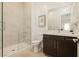 Modern bathroom showcasing a glass shower, a sleek vanity with a mirror, and neutral color palette at 11895 Skyline Arch Ct, Las Vegas, NV 89138