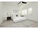 Bright bedroom with white walls, light wood floors, modern ceiling fan, and a large window at 11895 Skyline Arch Ct, Las Vegas, NV 89138