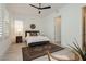 Bright bedroom with shuttered windows, a decorative wall hanging, and sleek ceiling fan at 11895 Skyline Arch Ct, Las Vegas, NV 89138