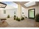 Modern home courtyard with a stone pillar, skylight, and minimalist landscaping at 11895 Skyline Arch Ct, Las Vegas, NV 89138