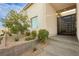 Modern home entrance featuring a decorative metal gate and landscaped garden at 11895 Skyline Arch Ct, Las Vegas, NV 89138