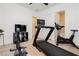 Bright exercise room featuring modern equipment, including a treadmill, rowing machine and stationary bike at 11895 Skyline Arch Ct, Las Vegas, NV 89138