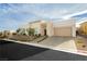 Modern single-story home showcasing a clean facade, two-car garage, and manicured front yard at 11895 Skyline Arch Ct, Las Vegas, NV 89138