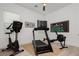 Well-equipped home gym with a treadmill, exercise bike, and rowing machine, perfect for fitness enthusiasts at 11895 Skyline Arch Ct, Las Vegas, NV 89138