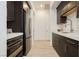 Well-lit kitchen with dark cabinets, stainless appliances and marble countertops at 11895 Skyline Arch Ct, Las Vegas, NV 89138