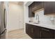 Bright kitchen showcasing dark wood cabinetry, marble counters, and a stainless refrigerator at 11895 Skyline Arch Ct, Las Vegas, NV 89138