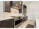 This modern kitchen features stainless steel appliances, dark wood cabinets, and marble countertops at 11895 Skyline Arch Ct, Las Vegas, NV 89138