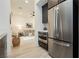 Modern kitchen with stainless steel appliances and views into adjacent living area at 11895 Skyline Arch Ct, Las Vegas, NV 89138