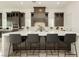 Modern kitchen featuring a large island, stylish seating and ample storage at 11895 Skyline Arch Ct, Las Vegas, NV 89138