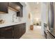 Kitchen with modern dark cabinetry, stainless steel appliances and marble countertops at 11895 Skyline Arch Ct, Las Vegas, NV 89138