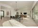 Open concept living and dining area featuring light wood floors and plenty of natural light at 11895 Skyline Arch Ct, Las Vegas, NV 89138