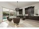 Stylish living room with a view of the pool through sliding glass doors at 11895 Skyline Arch Ct, Las Vegas, NV 89138