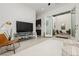 Bright living room with modern decor, wet bar, and seamless indoor-outdoor flow to a private courtyard at 11895 Skyline Arch Ct, Las Vegas, NV 89138