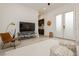 Living room with television set, stylish chair and view to modern kitchen at 11895 Skyline Arch Ct, Las Vegas, NV 89138