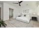 Bright bedroom with neutral tones, plush carpeting, and a contemporary ceiling fan at 11895 Skyline Arch Ct, Las Vegas, NV 89138