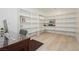 Spacious office area featuring wood floors, built-in shelving, and a desk at 11895 Skyline Arch Ct, Las Vegas, NV 89138