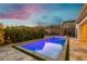 Inviting backyard pool area with lush landscaping, perfect for relaxation and enjoying outdoor living during sunset at 11895 Skyline Arch Ct, Las Vegas, NV 89138