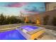 Heated pool and spa with patio furniture for entertaining guests at 11895 Skyline Arch Ct, Las Vegas, NV 89138