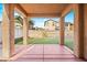 Covered patio overlooking a landscaped backyard with artificial grass and a view of surrounding houses at 1220 Earth Ct, North Las Vegas, NV 89032