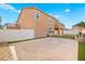 Expansive backyard featuring artificial grass, brick-paved patio, and well-maintained landscaping for outdoor enjoyment at 1220 Earth Ct, North Las Vegas, NV 89032