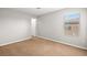 Bedroom featuring neutral carpet, window, and white trim at 1220 Earth Ct, North Las Vegas, NV 89032