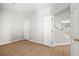 Bright bedroom featuring tile flooring, doorway to stairs and closet at 1220 Earth Ct, North Las Vegas, NV 89032