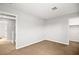 Hallway view shows neutral paint and carpet, leading to an open doorway at 1220 Earth Ct, North Las Vegas, NV 89032