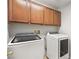 Efficient laundry room with matching washer and dryer set and storage cabinets above at 1220 Earth Ct, North Las Vegas, NV 89032