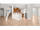 Open-concept living room with tile flooring and neutral walls, seamlessly flowing into the kitchen and dining areas at 1220 Earth Ct, North Las Vegas, NV 89032