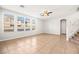 Bright living room with tile flooring, large windows, and a ceiling fan at 1220 Earth Ct, North Las Vegas, NV 89032