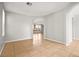 Open-concept living room with tile flooring, neutral paint and a large archway that flows into the kitchen at 1220 Earth Ct, North Las Vegas, NV 89032