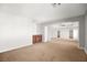 Spacious living room featuring neutral carpet, built in cabinets, and arched doorways at 1220 Earth Ct, North Las Vegas, NV 89032