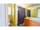 Well-lit bathroom featuring a shower-tub combination with a dark shower curtain and a single sink vanity at 1300 Sand Castle Ave, Las Vegas, NV 89183