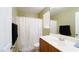 Bathroom with shower/tub combination with white curtain, white vanity and fixtures, and window with white shutters at 1300 Sand Castle Ave, Las Vegas, NV 89183