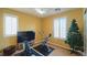 Cozy bedroom featuring neutral walls, windows with shutters, ceiling fan and complete with workout equipment and Christmas tree at 1300 Sand Castle Ave, Las Vegas, NV 89183