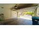 Spacious garage with an open garage door revealing the outside street view and a blue recycling bin at 1300 Sand Castle Ave, Las Vegas, NV 89183